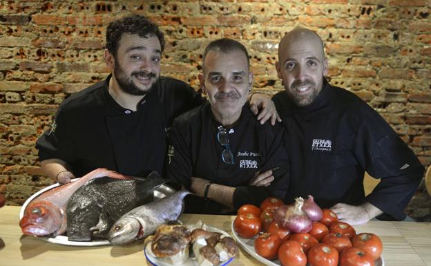 Joseba Irusta posa entre el cocinero Urtzi Ruiz y el jefe de sala Íñigo Serrano con género utilizado en su restaurante./Maite Bartolomé